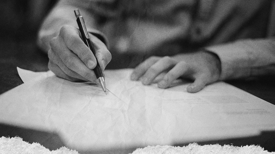 Man writing down key factors for choosing the right MSP for his business.